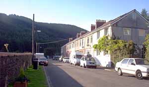 View of the street, showing the house and mountains beyond